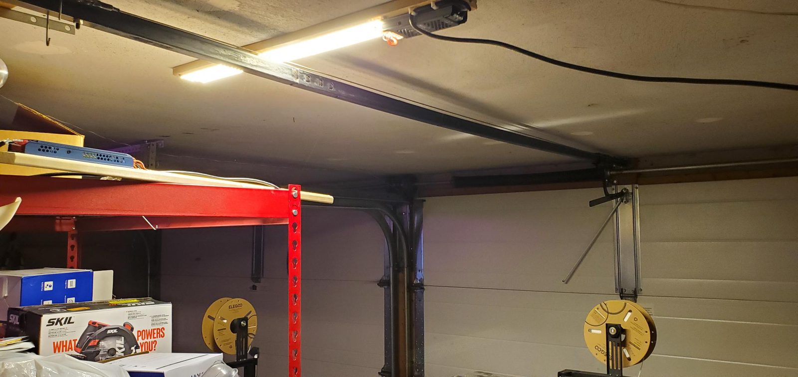 Long LED shop lights mounted to the garage ceiling