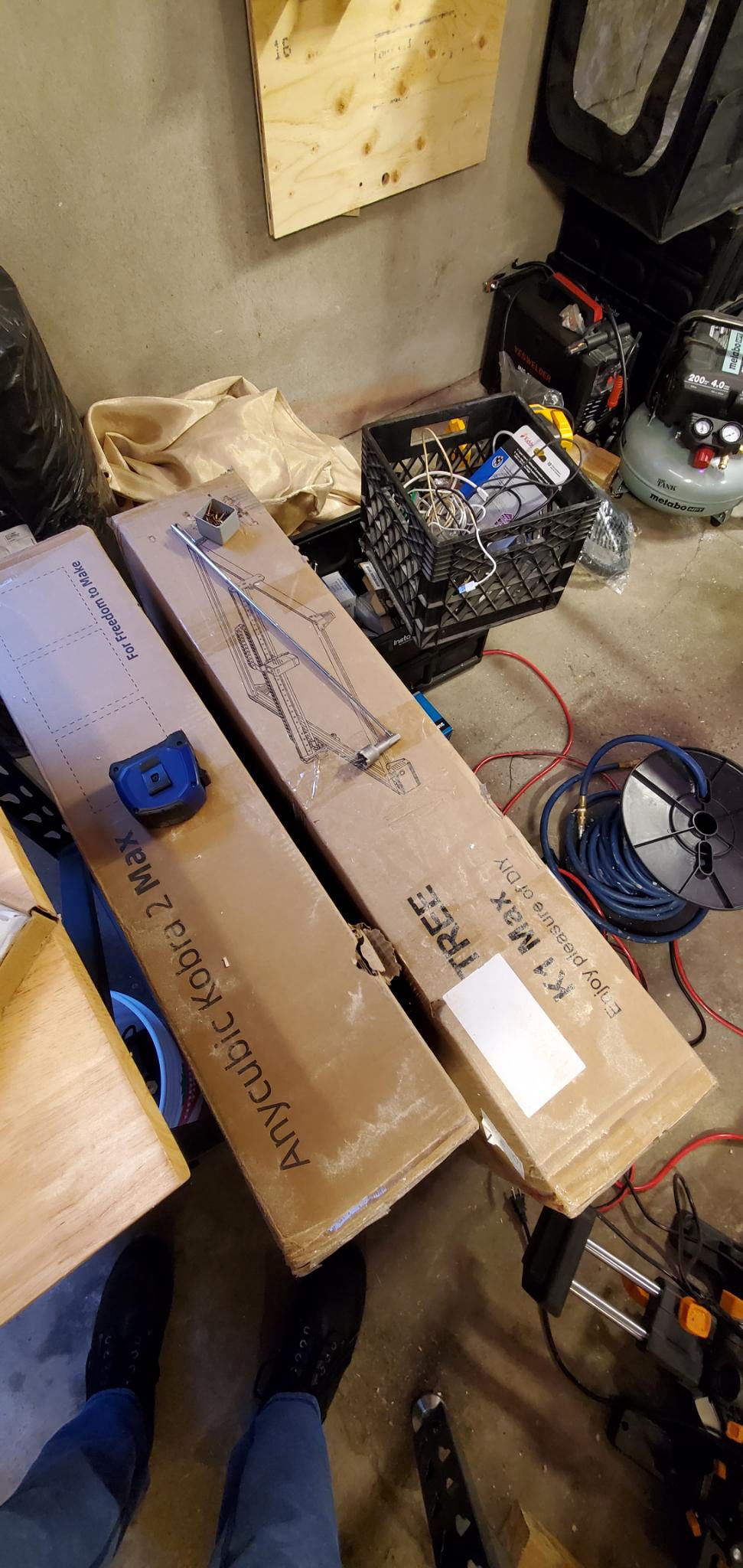Workshop floor with large-format 3D printer and compressor